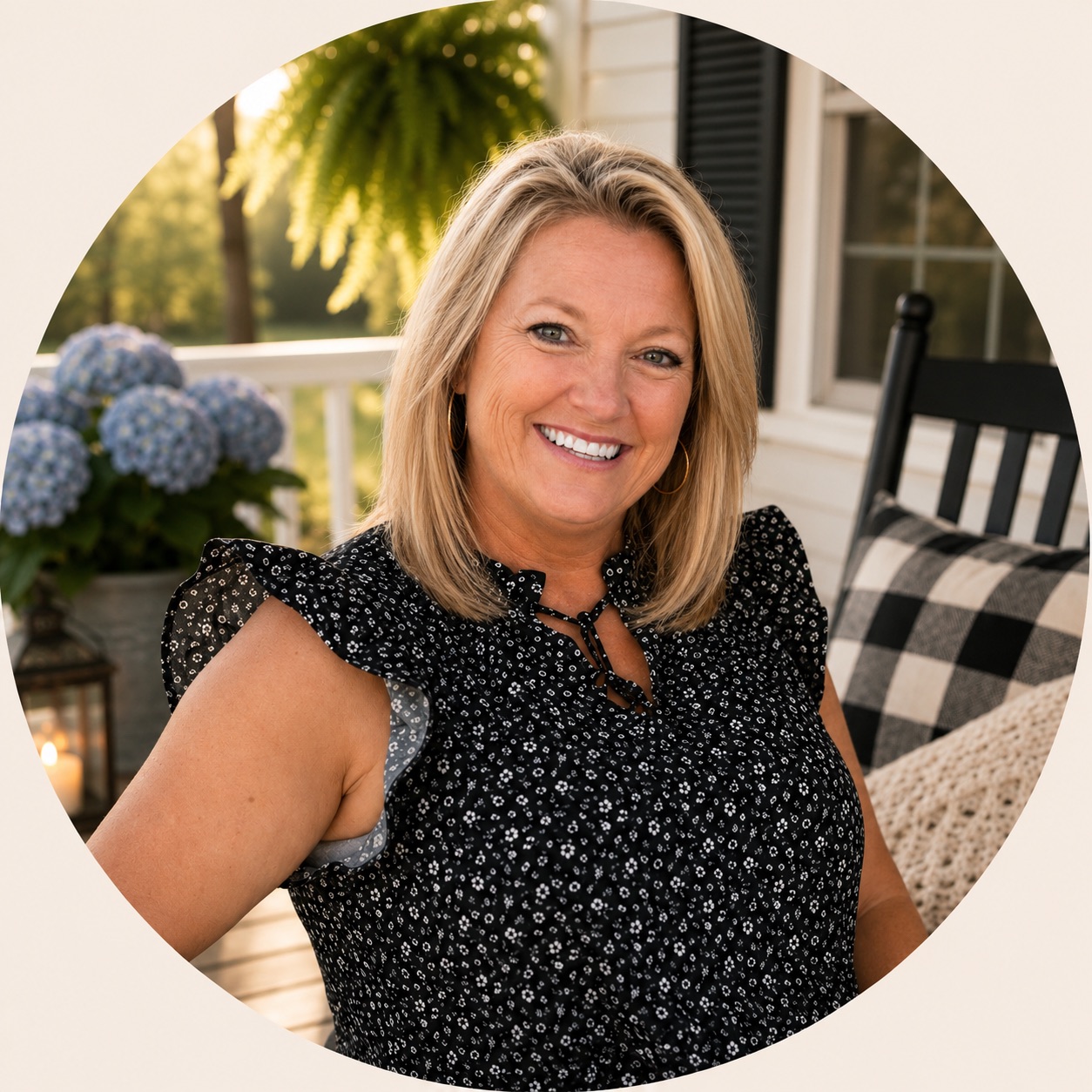 Danielle smiling while seated on a front porch